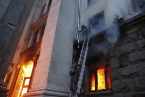 People wait to be rescued on the second storey's ledge during a fire at the trade union building in Odessa