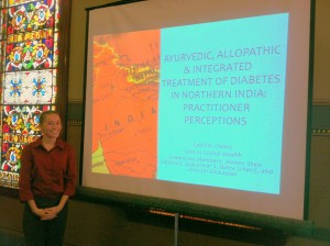 alum Camille Clancy defending her thesis on Ayurveda and integrative medicine in India this past spring.