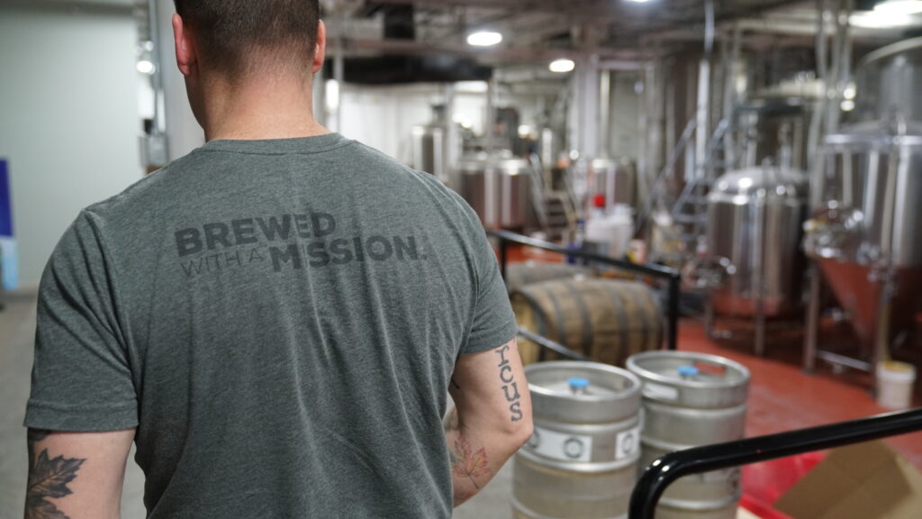 Brewed with a Mission logo on t-shirt