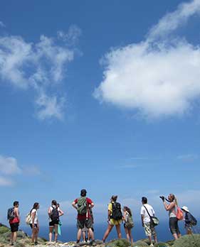students standing at top of mountain
