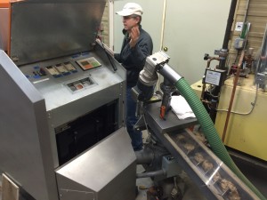 Chris Davis (Meach Cove Trust) prepares the boiler and combustion testing equipment for a trial run of the new fuel.