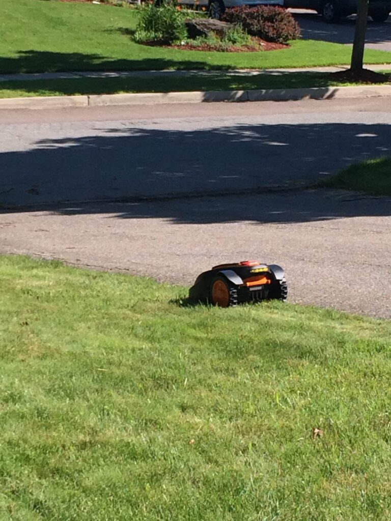 Mower with two wheels on the driveway