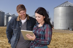 A royalty free image from the farming industry of a farmer couple using a tablet computer.
