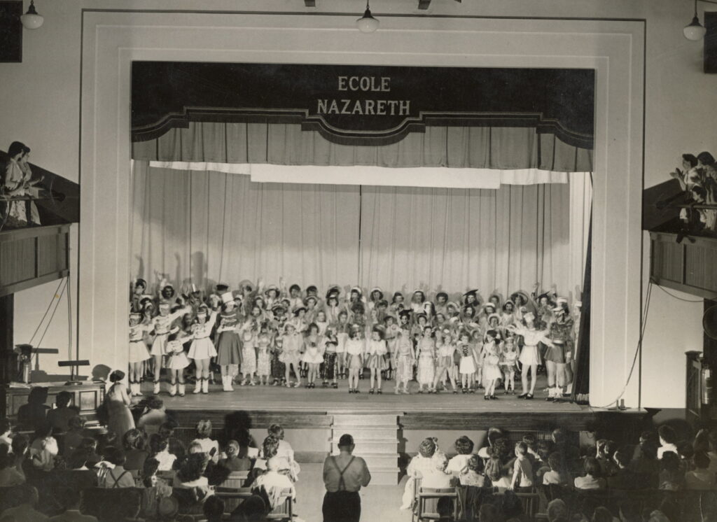 Audience in school auditorium applauds at the May 1952 recital.
