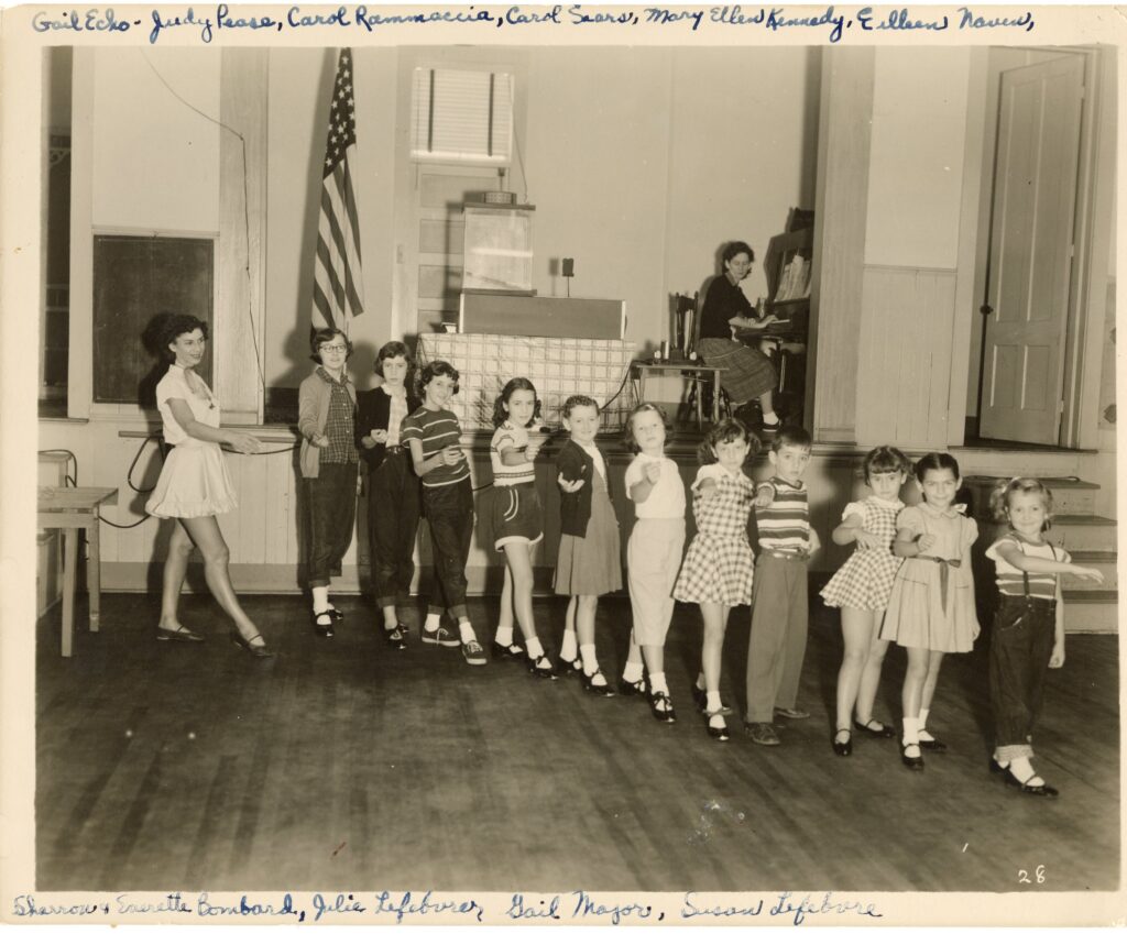 Dance teacher Nulty and young students practice in the studio.