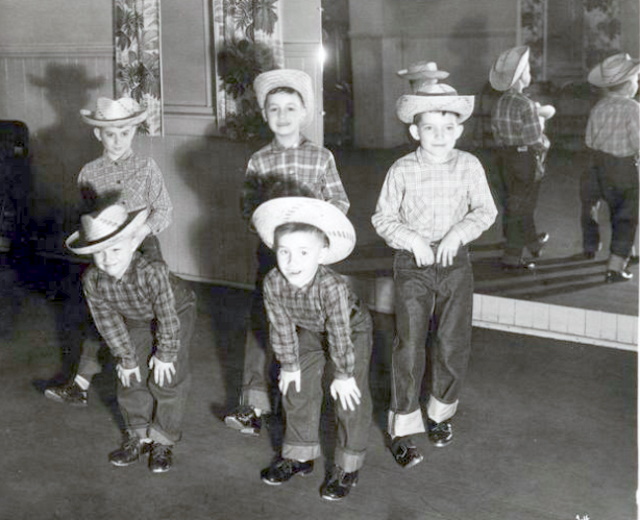 Five young tap dancers in cowboy hats, flannel shirts, and jeans