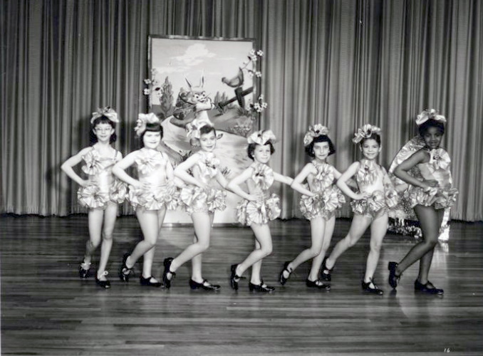 Young dancers in costume on school stage