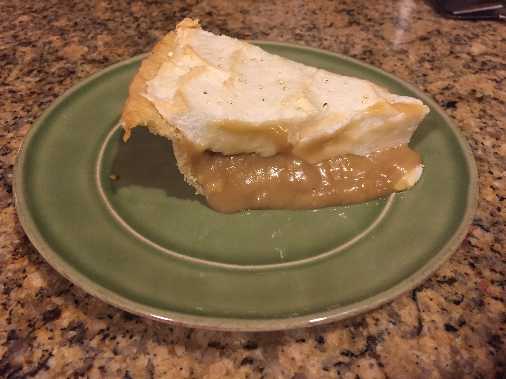 A slice of maple pie on a green plate.