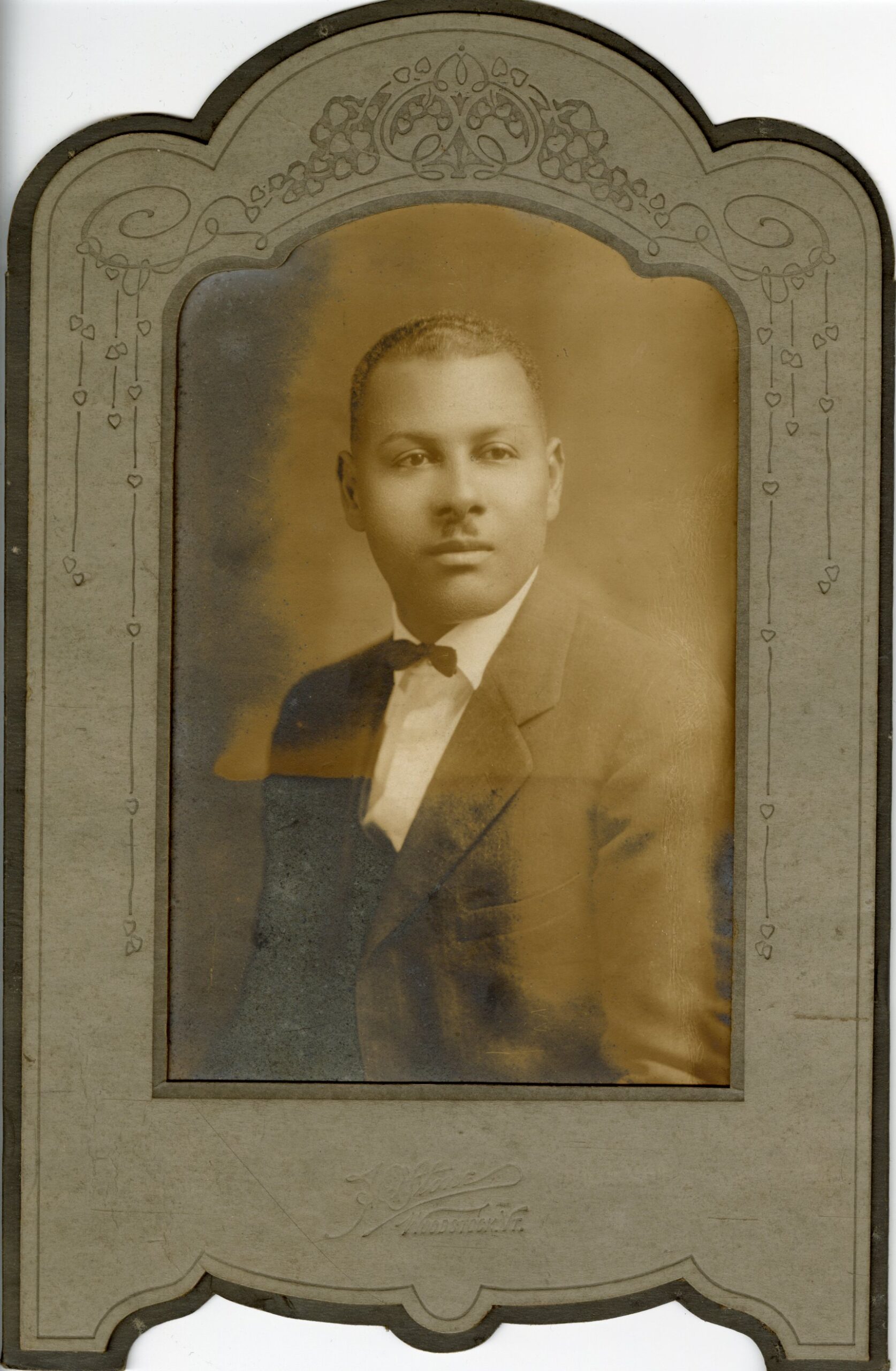 Studio portrait of a young Black man in a suit.