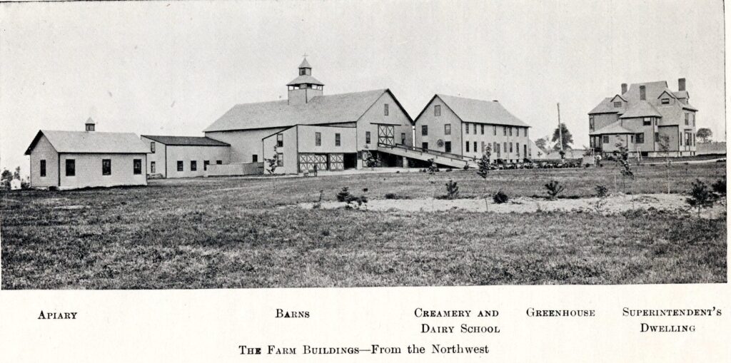Photograph of the UVM farm buildings, including left to right, the apiary, barns, creamery and dairy school, the greenhouse and the superintendent's house.