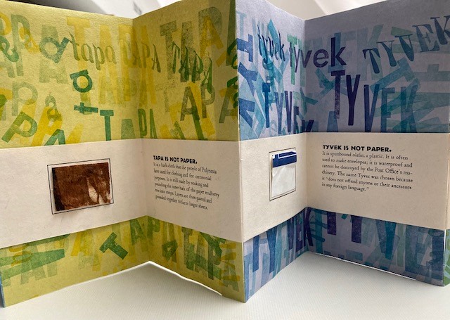 Image shows several pages of the accordion book, Not Paper, with samples and descriptions of tapa and tyvek.