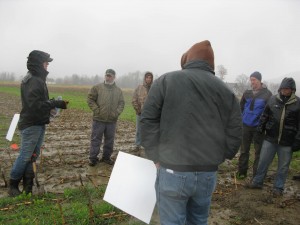 Meeting farmers where they are. On a cold & rainy November day, Kirsten leads a field day demonstrating cover crops in silage corn acreage.