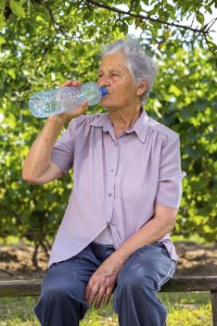 woman on fence drinking water