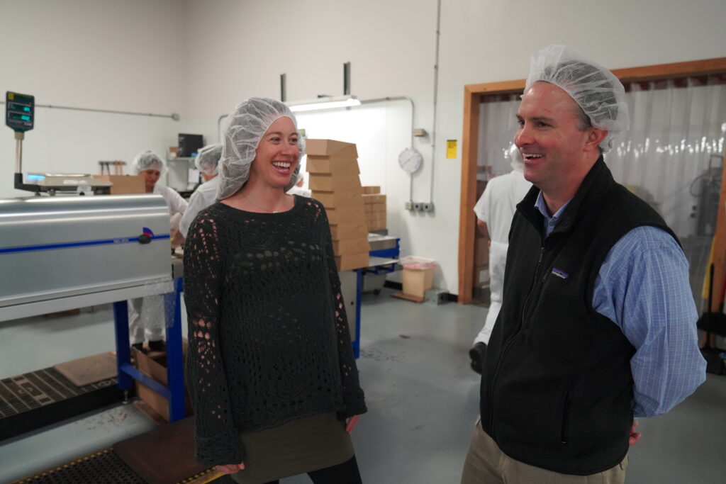 Julia Birnn Fields speaking with Attorney General T.J. Donovan at Birnn Chocolates of Vermont