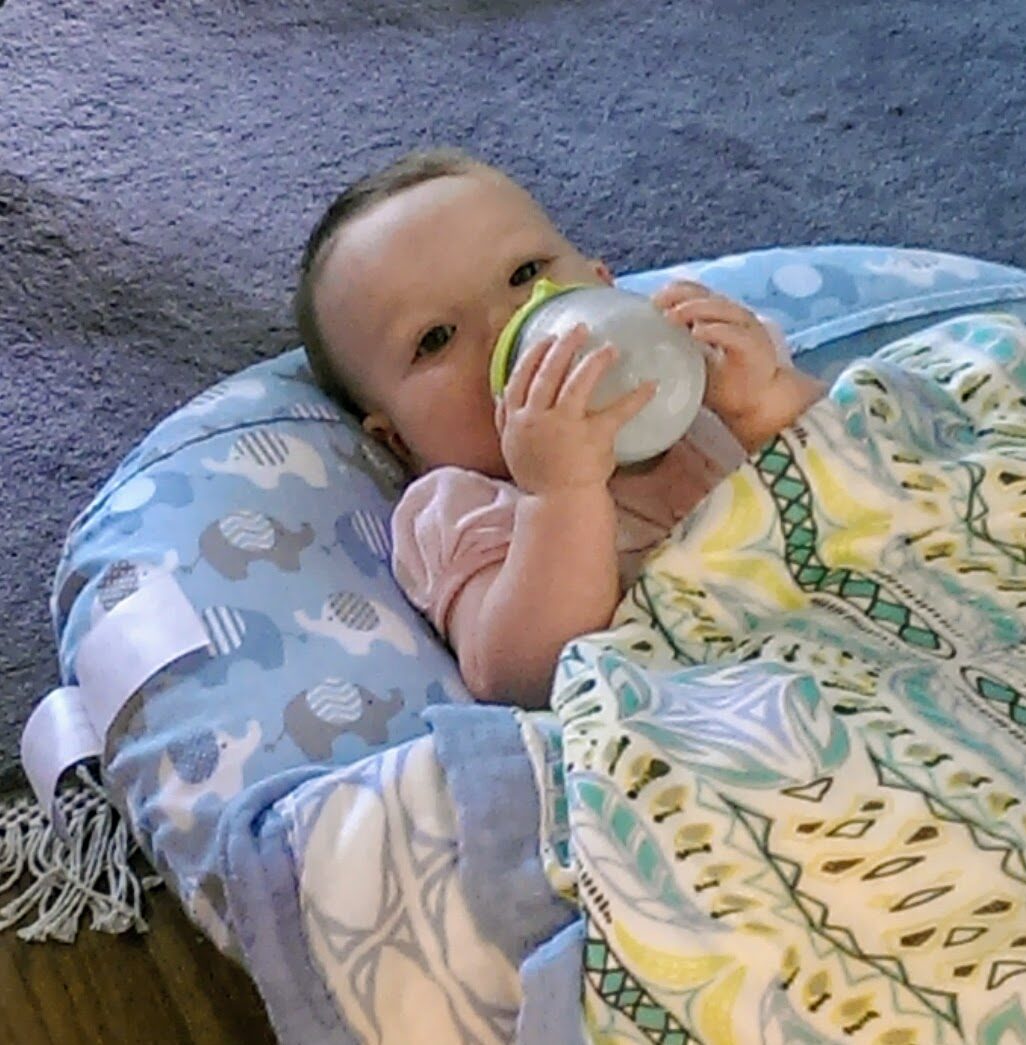 Baby drinking formula from a bottle