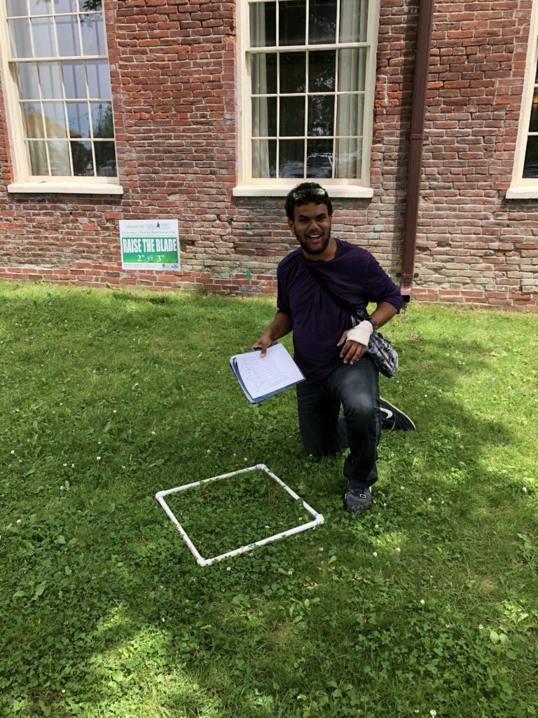 Photo of a student with a 1 m square quadratic lying on the grass