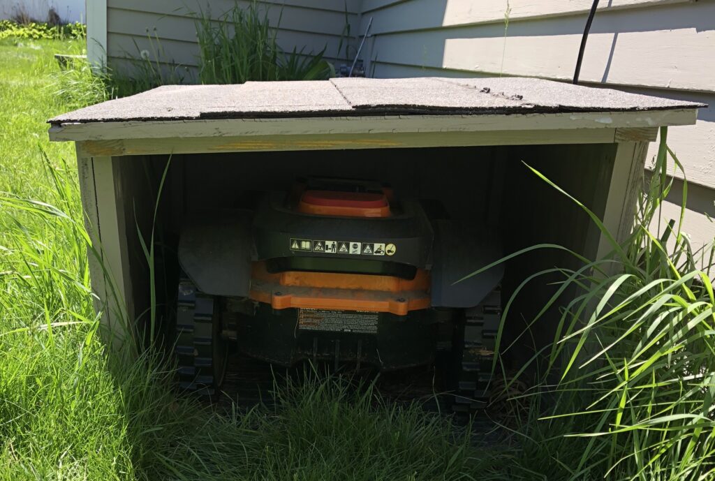 Mo in his finished doghouse, complete with shingled roof.