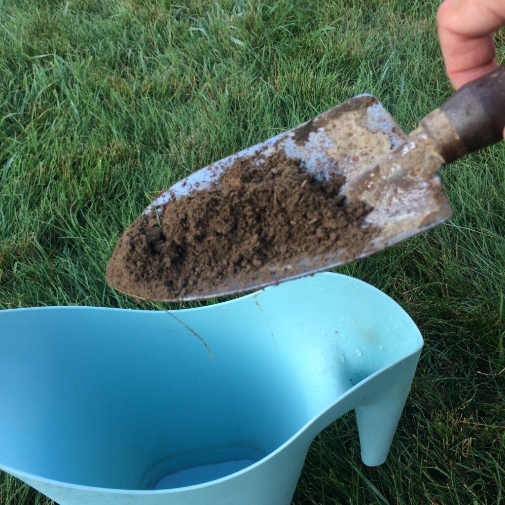 Trowel with that 1" wide soil sample being dumped into a container.