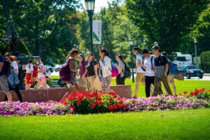 Students and families walking in the UVM University Green