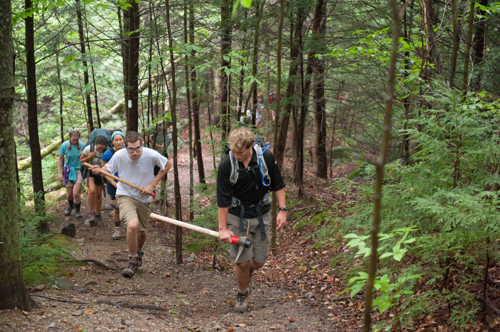 UVM students hiking in the woods